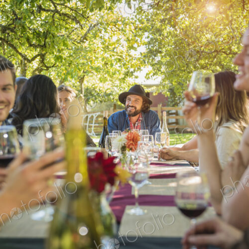 Friends drinking wine at party outdoors Friends drinking wine at party outdoors