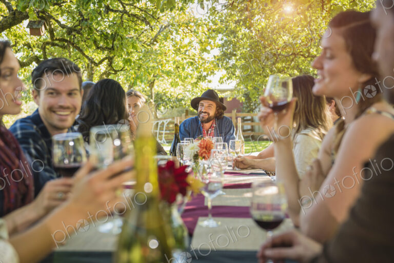 Friends drinking wine at party outdoors