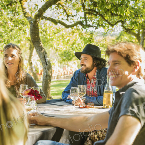 Friends drinking wine at party outdoors Friends drinking wine at party outdoors