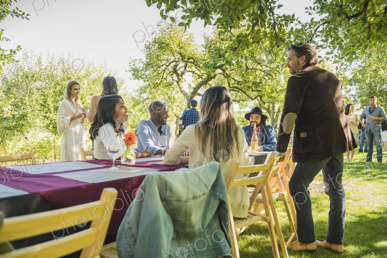Friends drinking wine at party outdoors