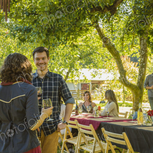 Friends drinking wine at party outdoors Friends drinking wine at party outdoors
