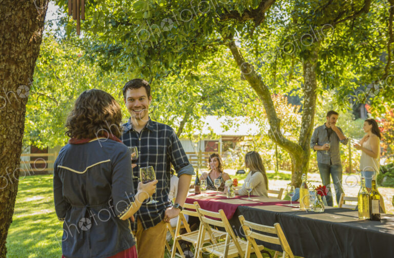 Friends drinking wine at party outdoors