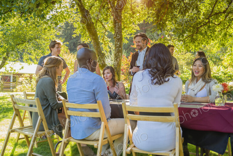 Friends drinking wine at party outdoors
