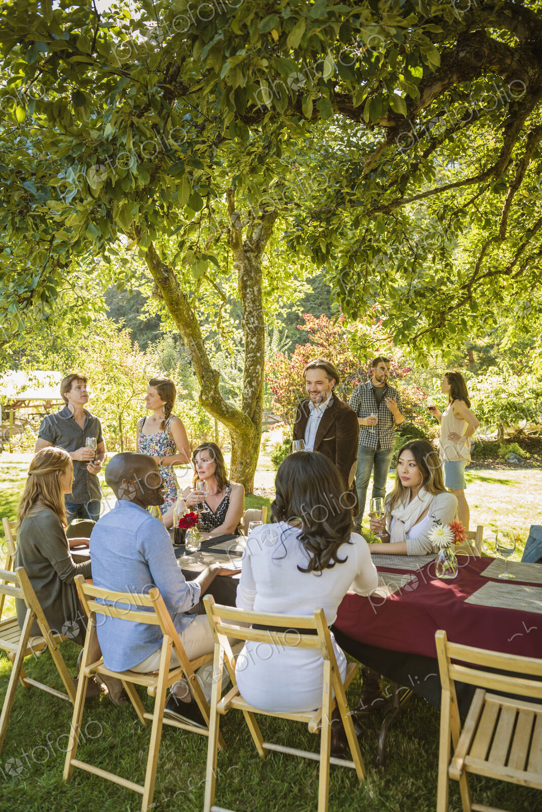 Friends drinking wine at party outdoors