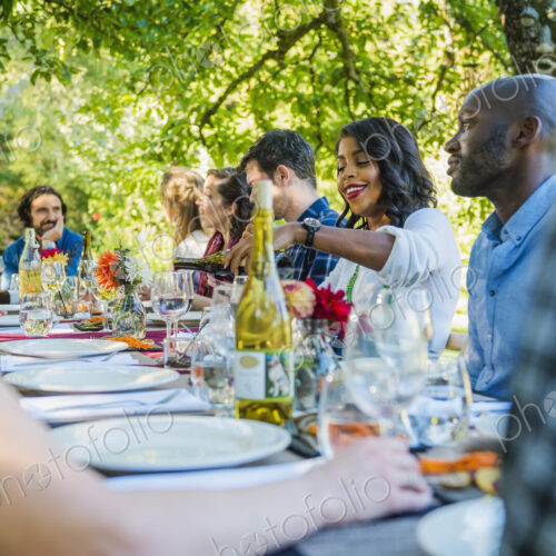 Friends enjoying wine at party outdoors Friends enjoying wine at party outdoors