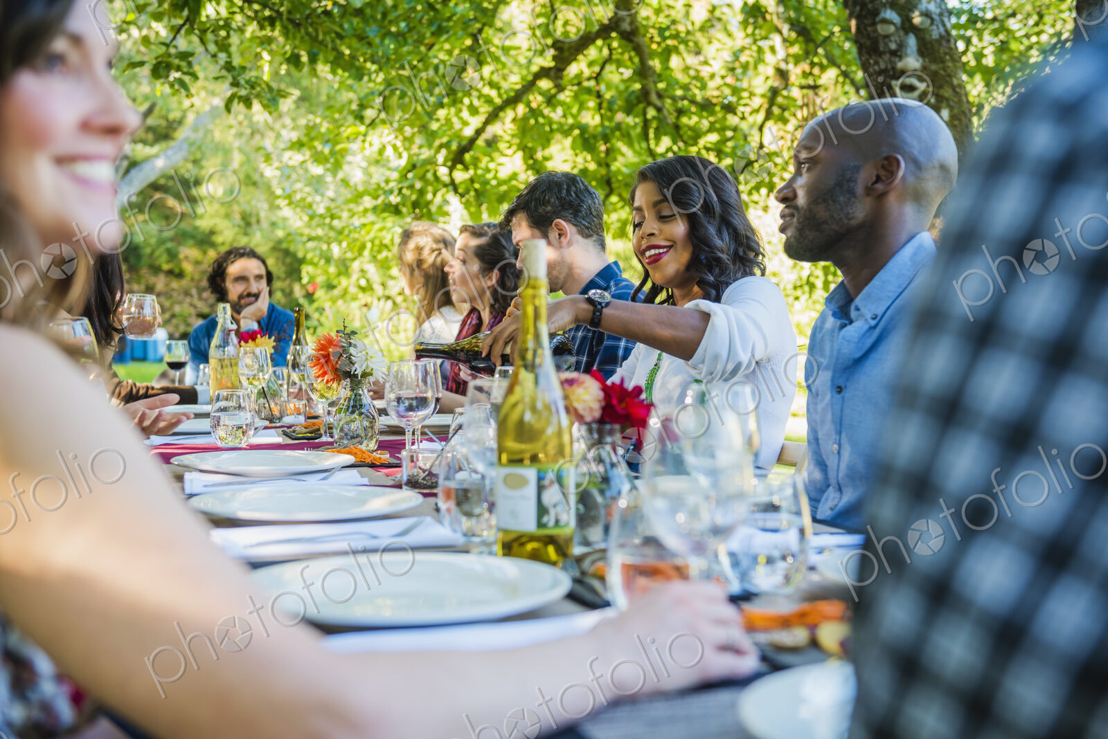 Friends enjoying wine at party outdoors