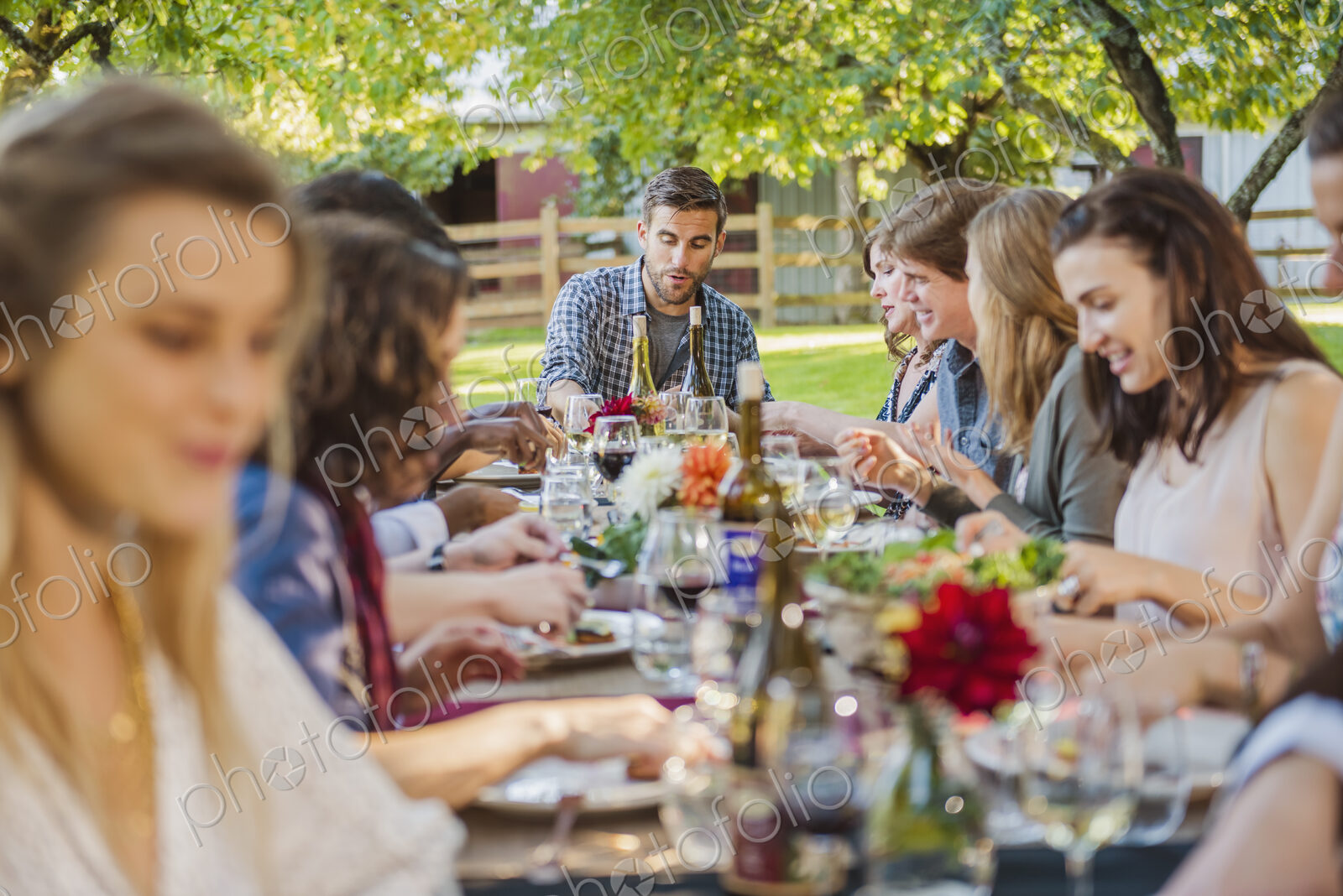 Friends enjoying wine at party outdoors