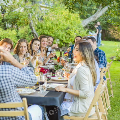 Friends enjoying wine at party outdoors Friends enjoying wine at party outdoors