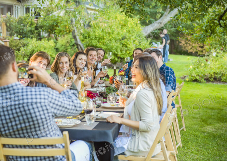 Friends enjoying wine at party outdoors