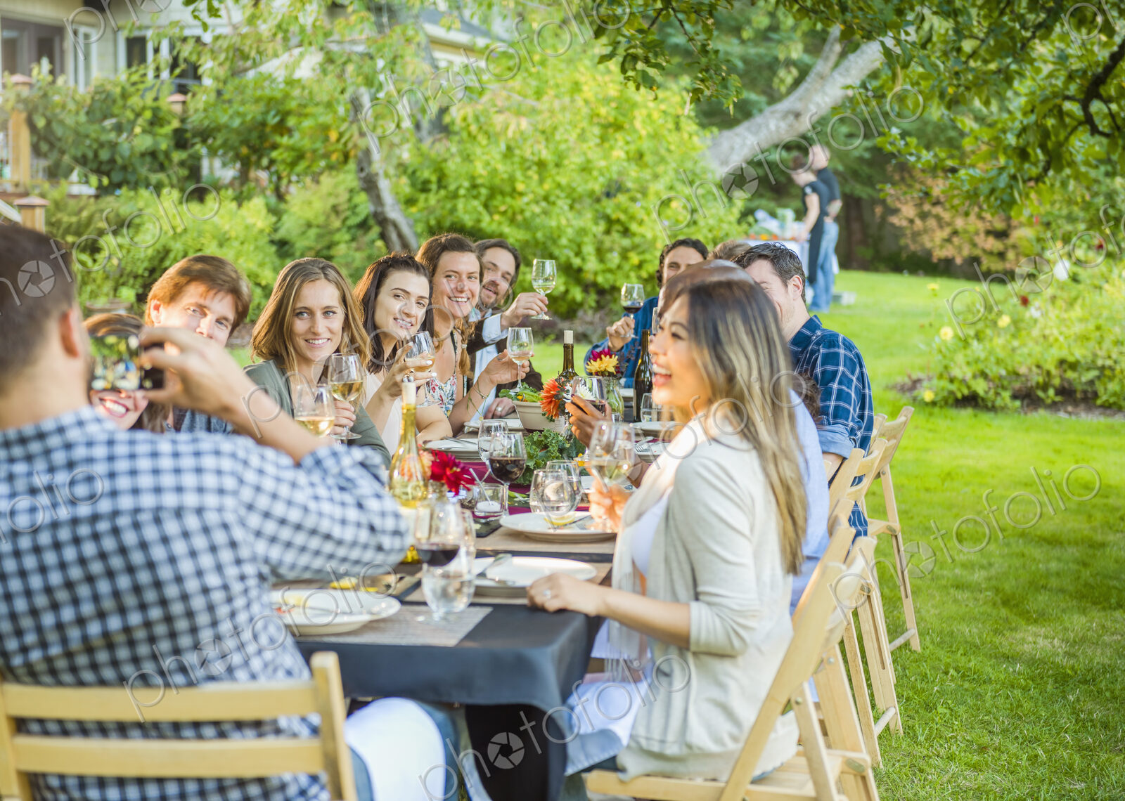 Friends enjoying wine at party outdoors