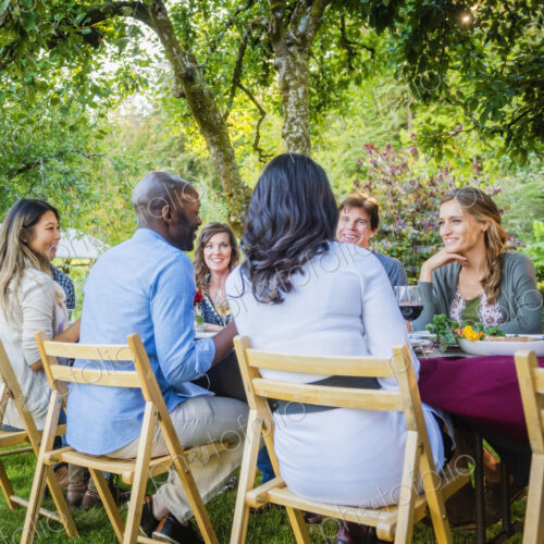 Friends enjoying wine at party outdoors Friends enjoying wine at party outdoors