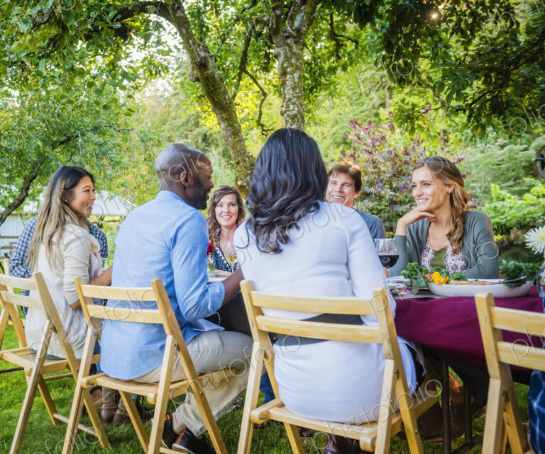 Friends enjoying wine at party outdoors