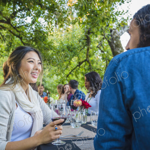 Friends enjoying wine at party outdoors Friends enjoying wine at party outdoors