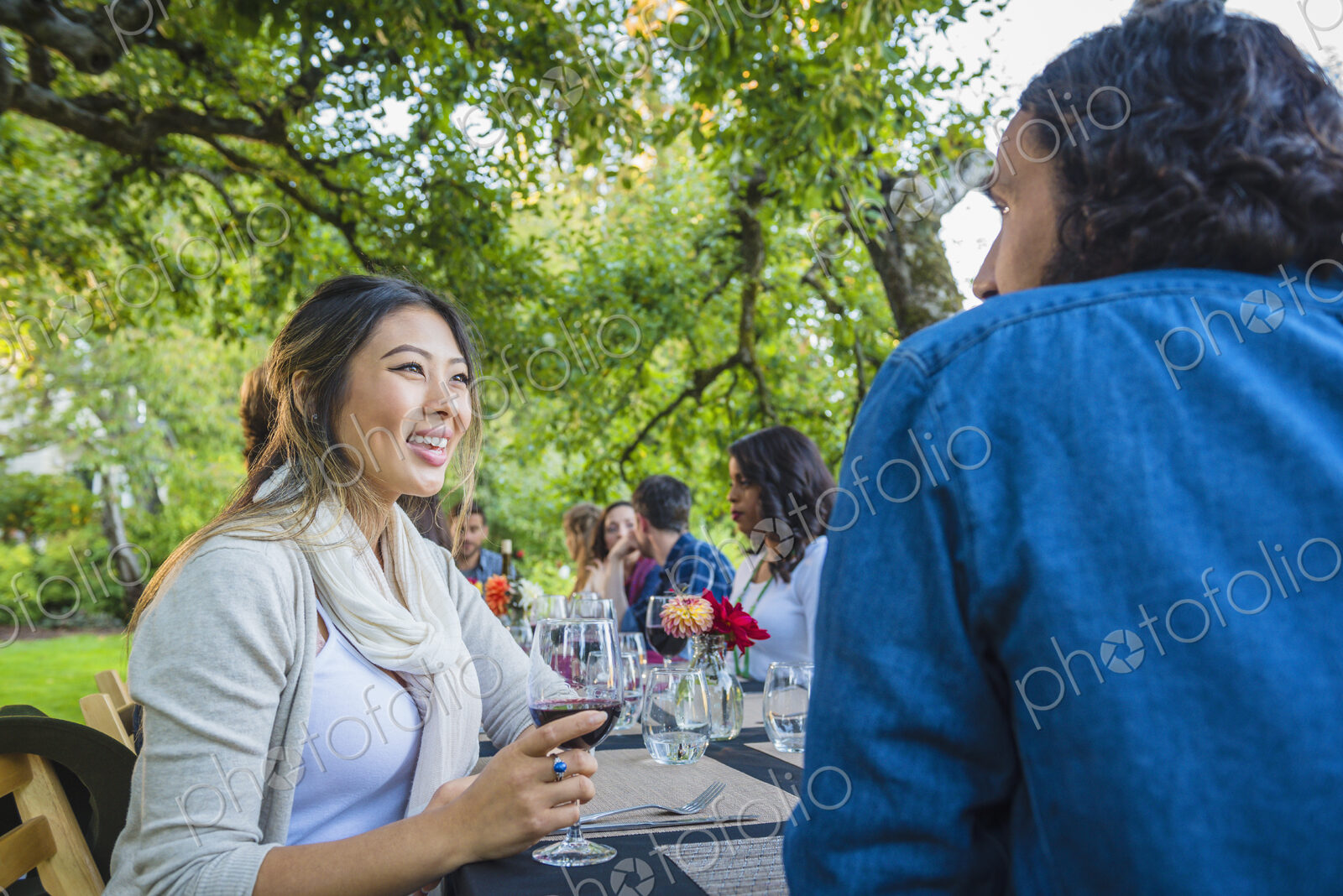 Friends enjoying wine at party outdoors