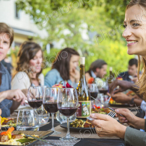Friends enjoying wine at party outdoors Friends enjoying wine at party outdoors