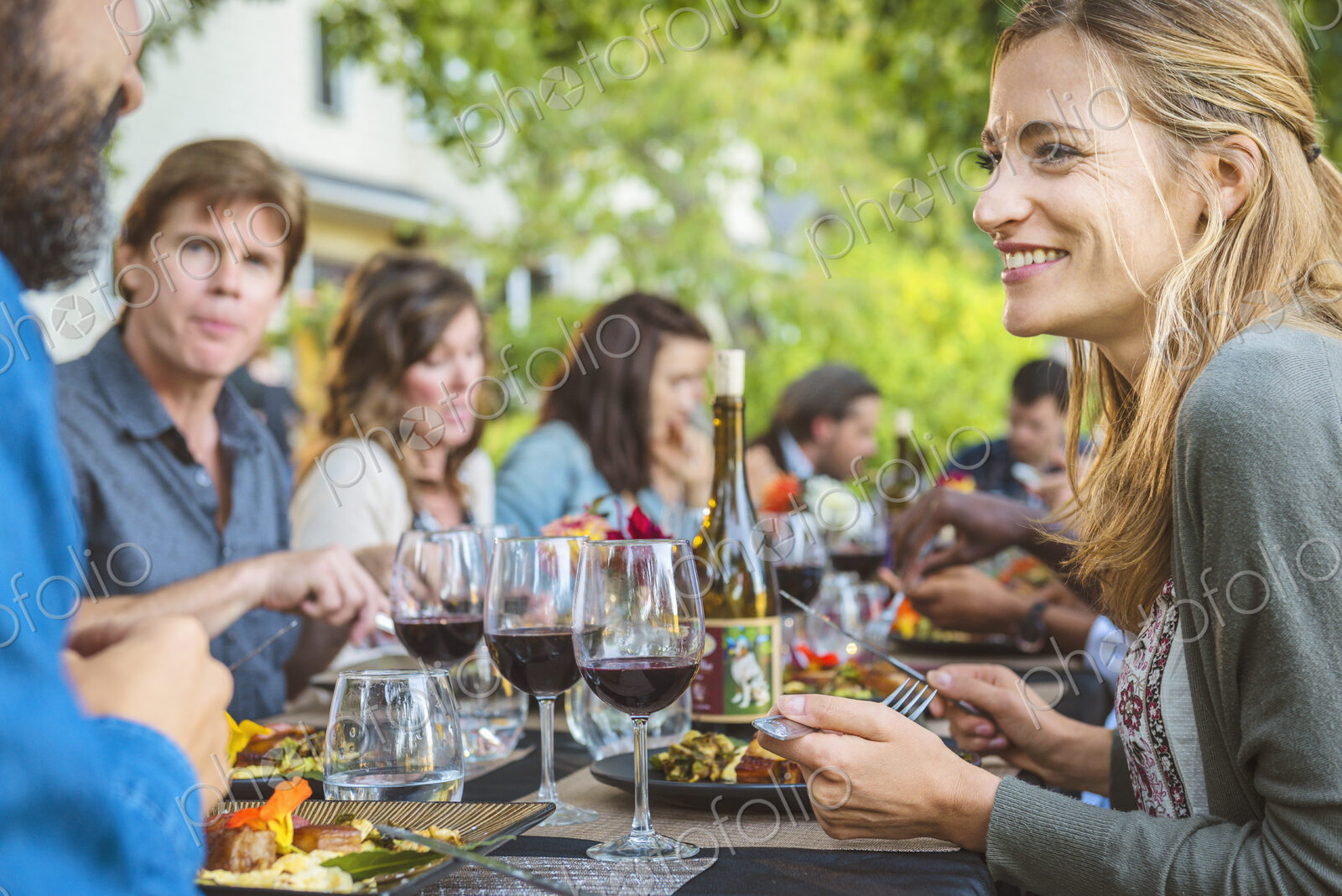 Friends enjoying wine at party outdoors