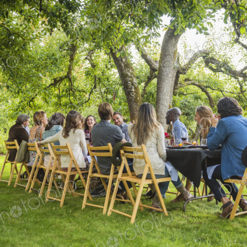 Friends enjoying wine at party outdoors Friends enjoying wine at party outdoors