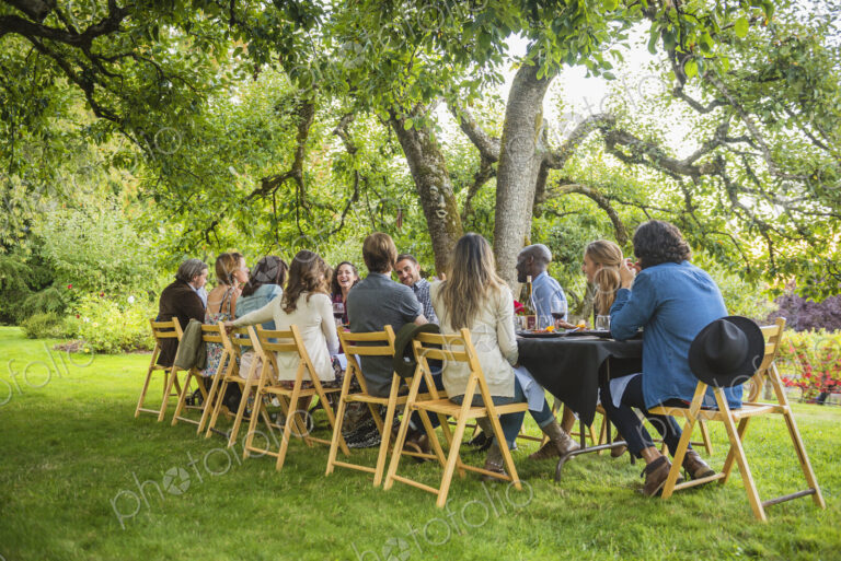 Friends enjoying wine at party outdoors