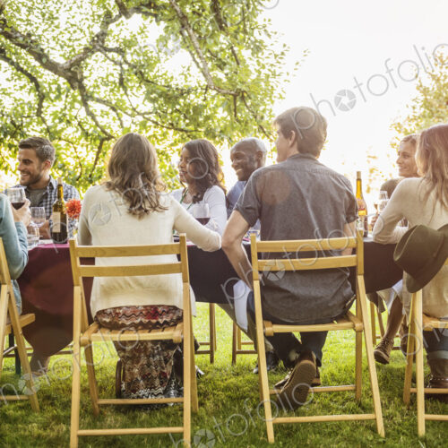 Friends enjoying wine at party outdoors Friends enjoying wine at party outdoors