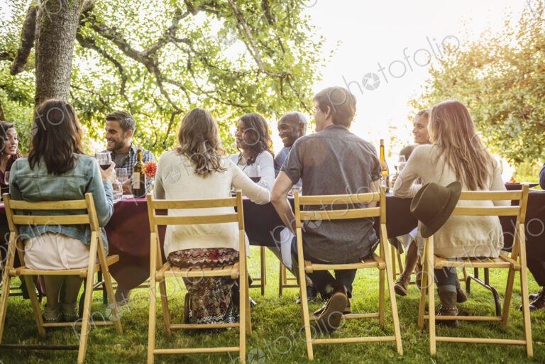 Friends enjoying wine at party outdoors