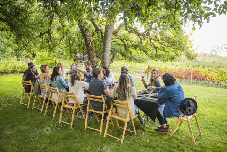 Friends enjoying wine at party outdoors