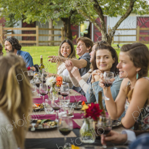 Friends enjoying wine at party outdoors Friends enjoying wine at party outdoors