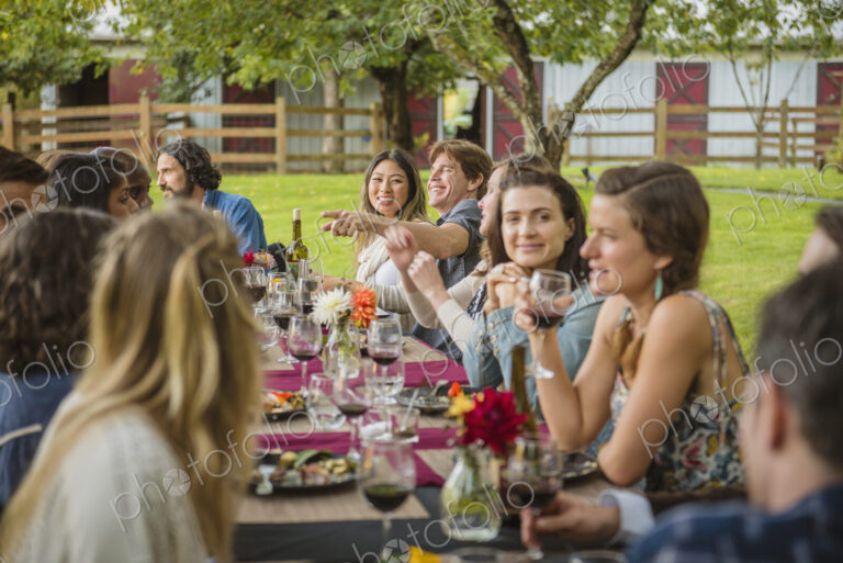 Friends enjoying wine at party outdoors