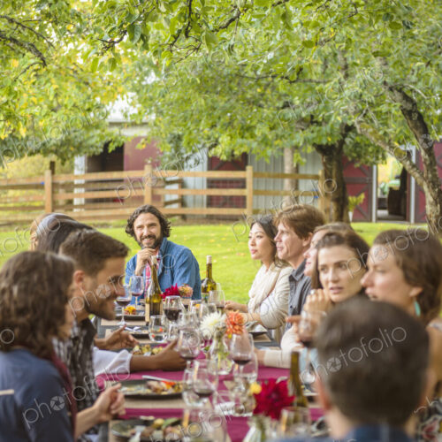 Friends enjoying wine at party outdoors Friends enjoying wine at party outdoors