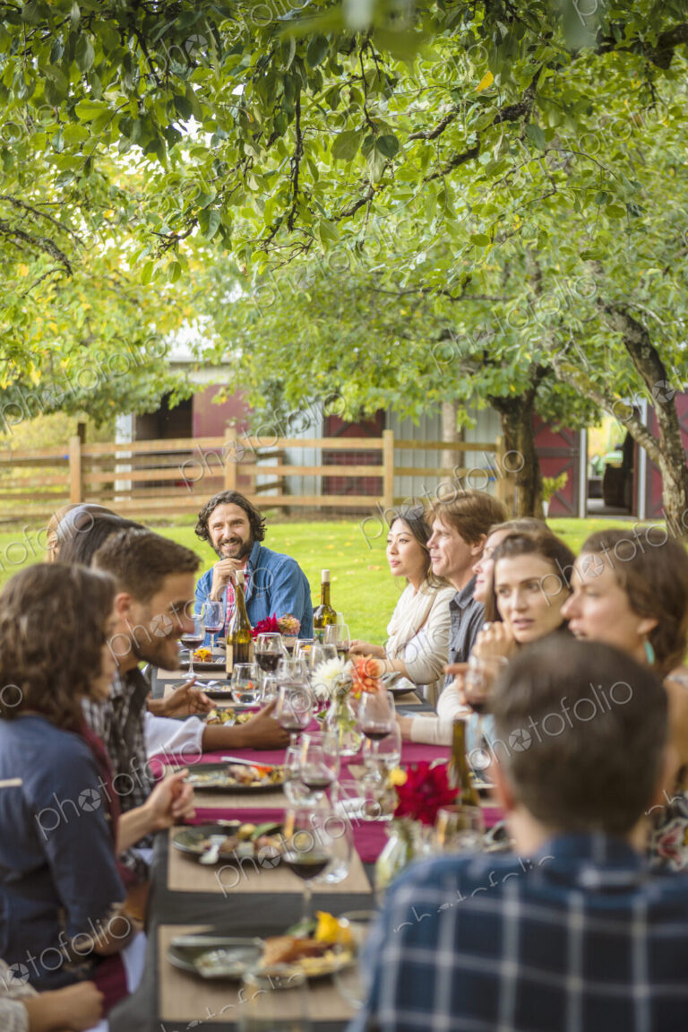 Friends enjoying wine at party outdoors