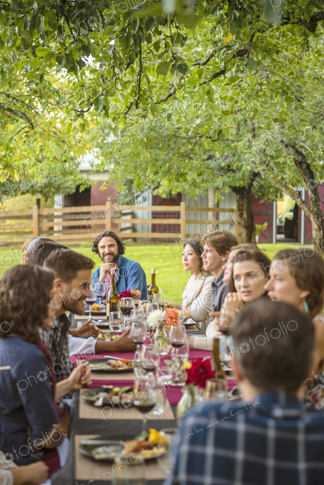 Friends enjoying wine at party outdoors