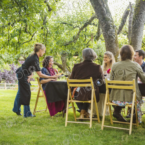 Friends enjoying wine at party outdoors Friends enjoying wine at party outdoors