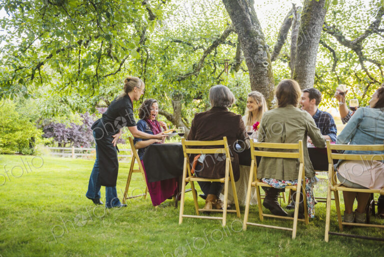 Friends enjoying wine at party outdoors