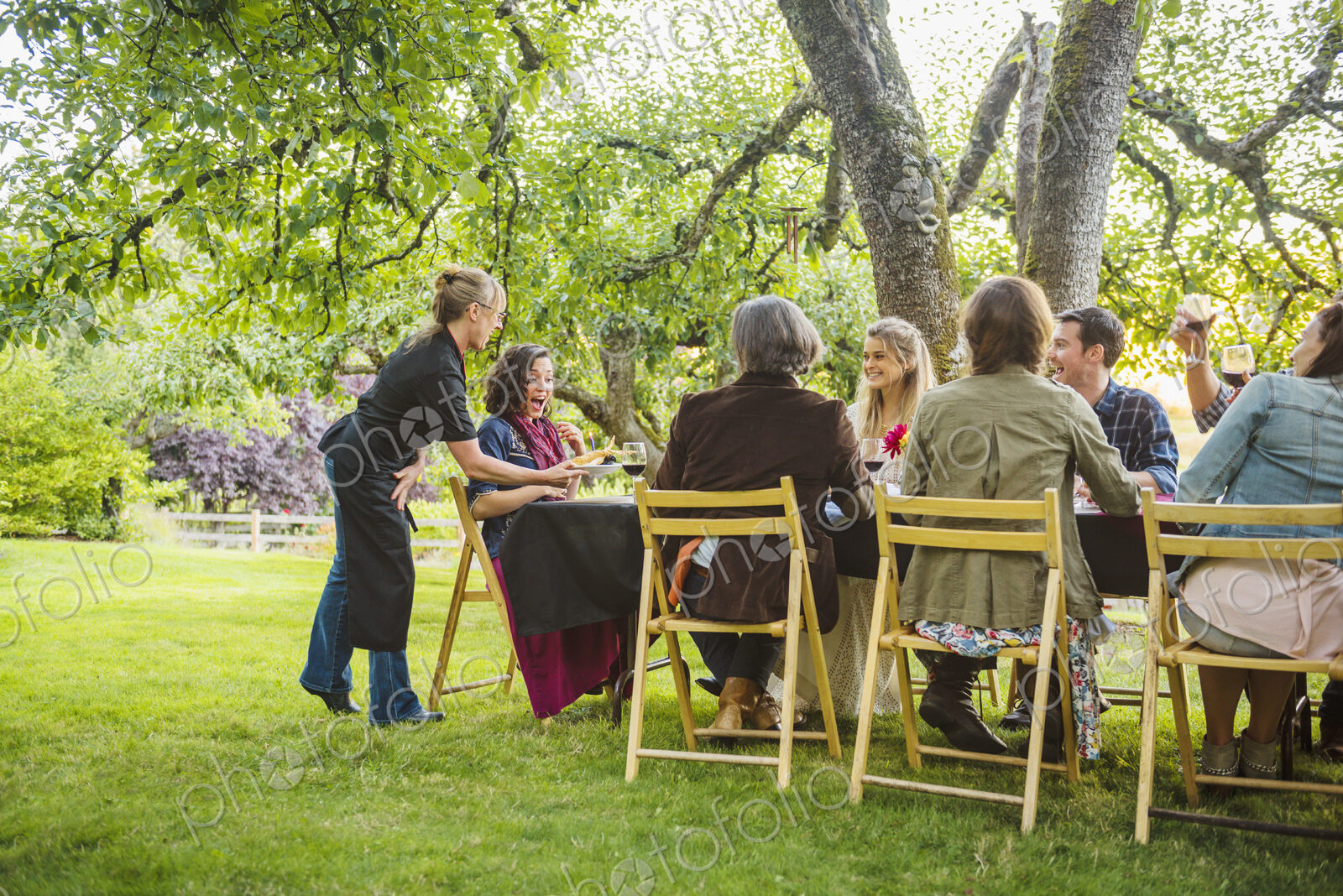 Friends enjoying wine at party outdoors
