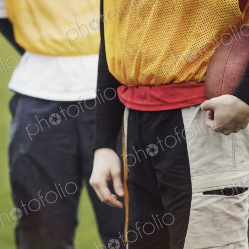 Friends in sports gear getting ready for a weekend American Flag Football game.