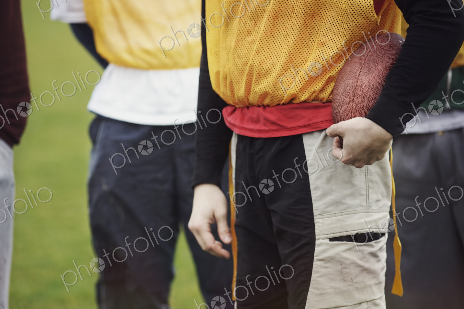 Friends in sports gear getting ready for a weekend American Flag Football game.