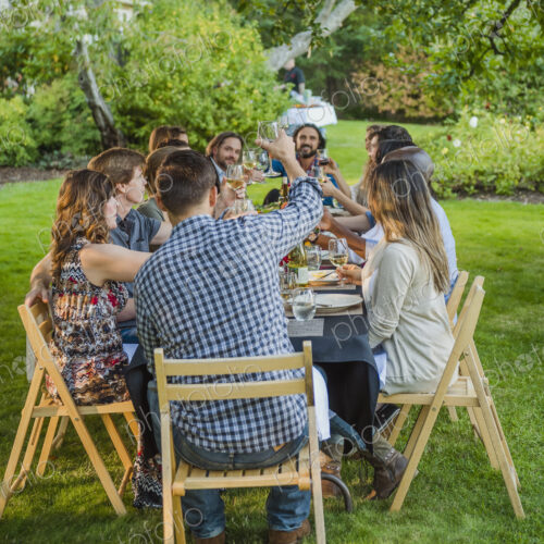 Friends toasting with wine at party outdoors Friends toasting with wine at party outdoors
