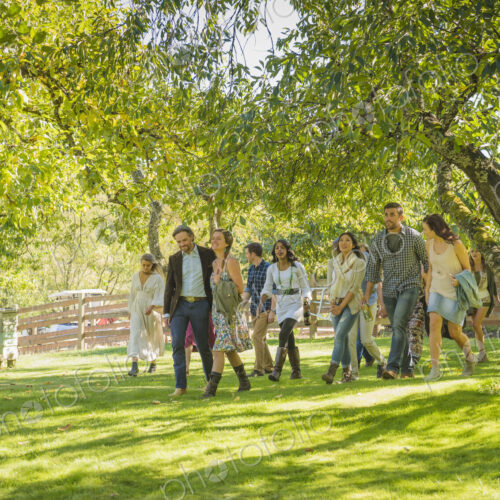 Friends walking grass under trees