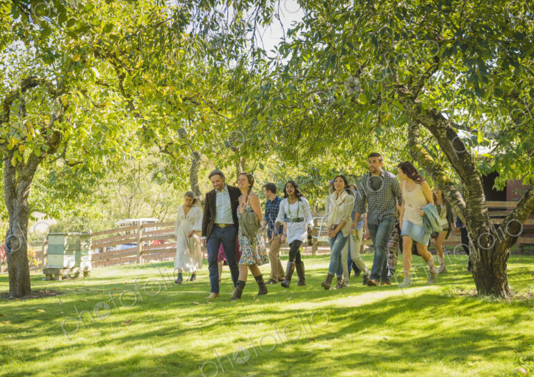 Friends walking grass under trees