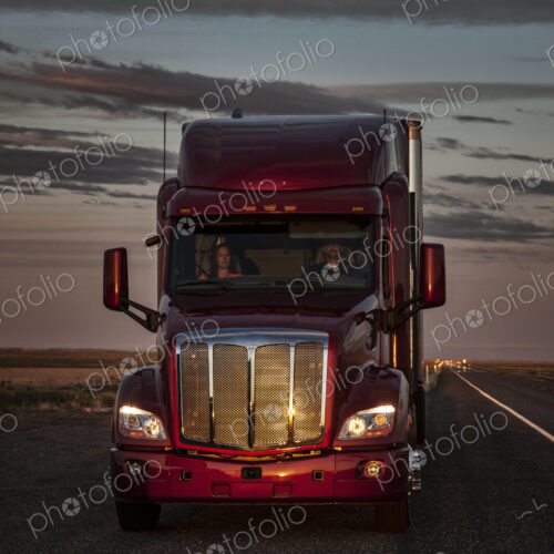 Front view of the cab of a commercial truck on the highway. Front view of the cab of a commercial truck on the highway.