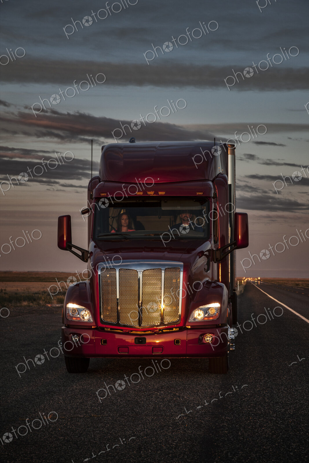 Front view of the cab of a commercial truck on the highway.