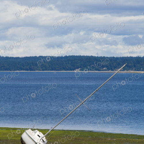 Frye Cove County Park on Eld Inlet, South Puget Sound, a boat beached on the sand. Frye Cove County Park on Eld Inlet, South Puget Sound, a boat beached on the sand.