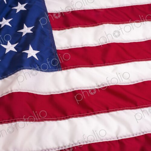 Full-frame close-up of the United States flag showing detailed stitching and texture -… Full-frame close-up of the United States flag showing detailed stitching and texture -…