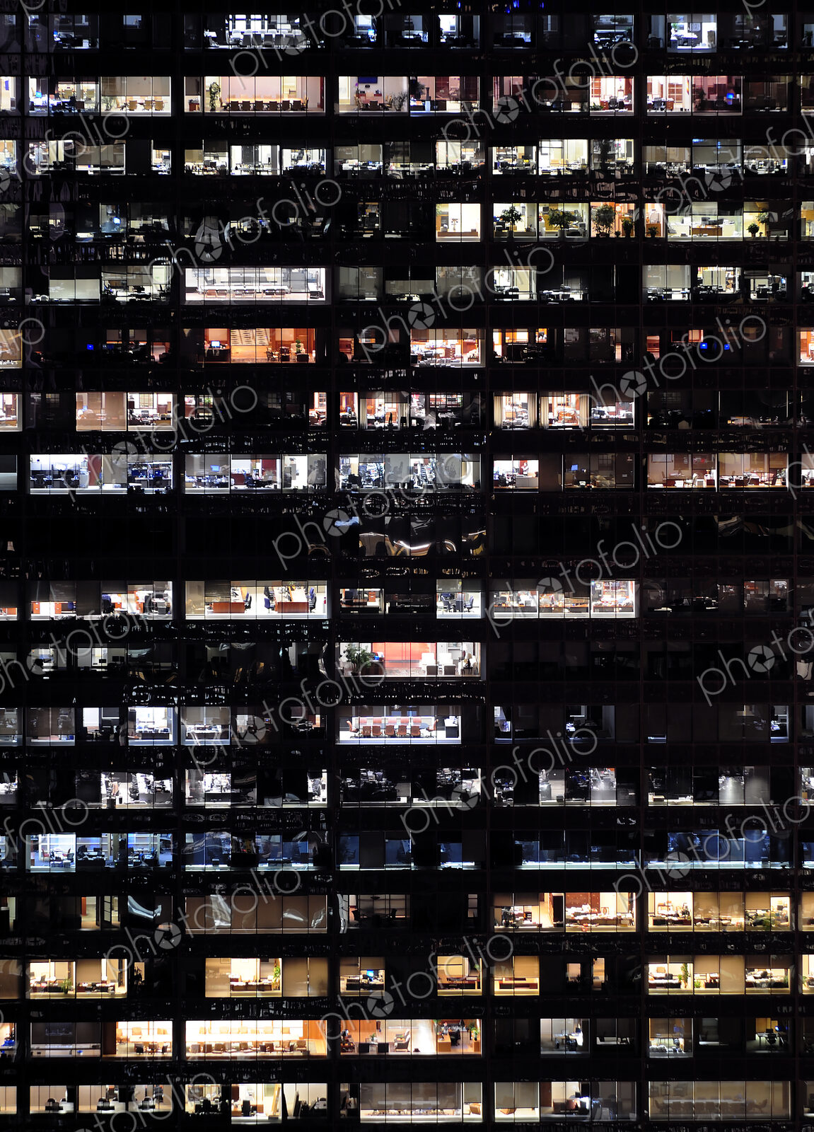 Full frame of highrise building windows at night