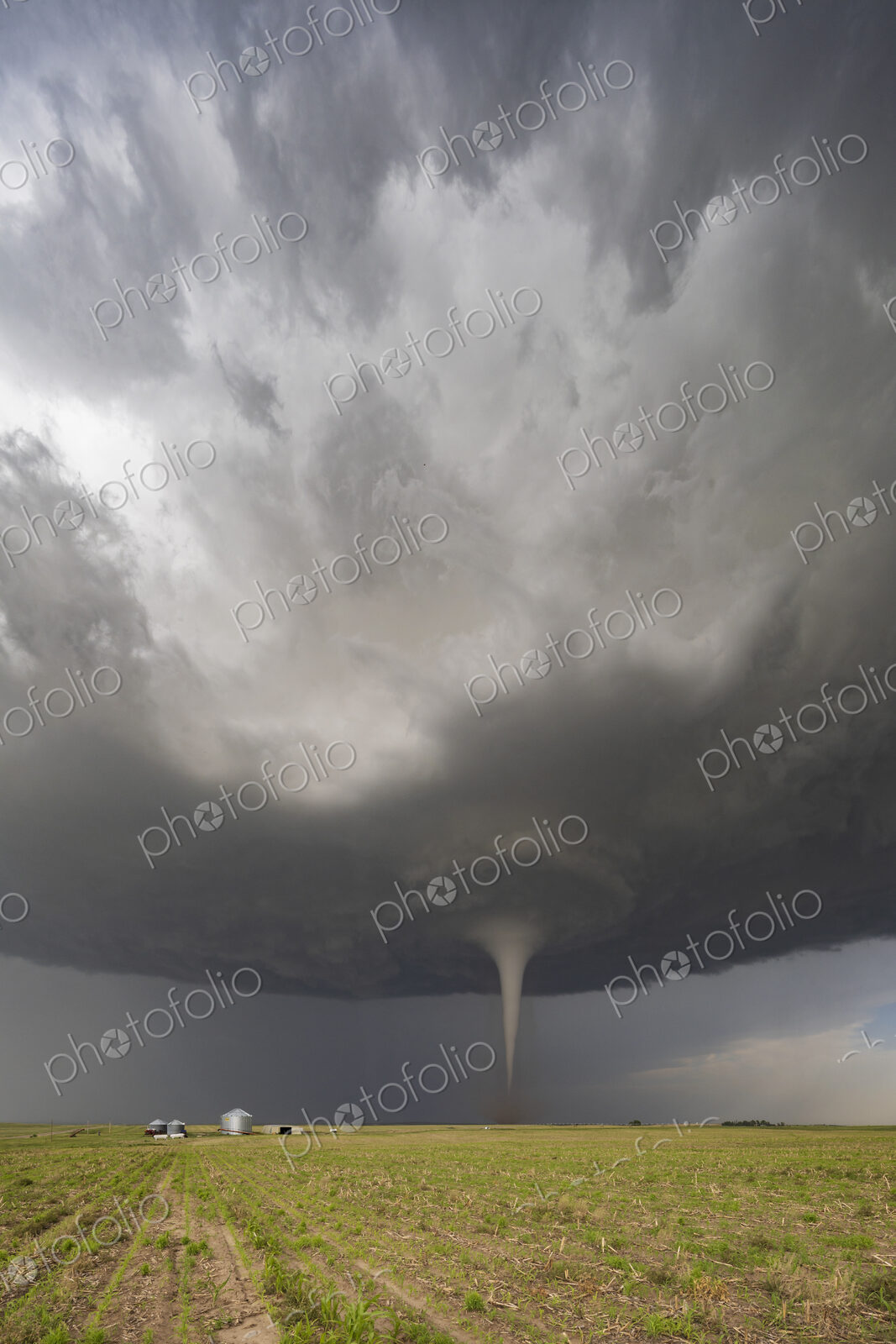 Fully Condensed Tornado, a rotating column of air reaching to the ground, a defined shape.