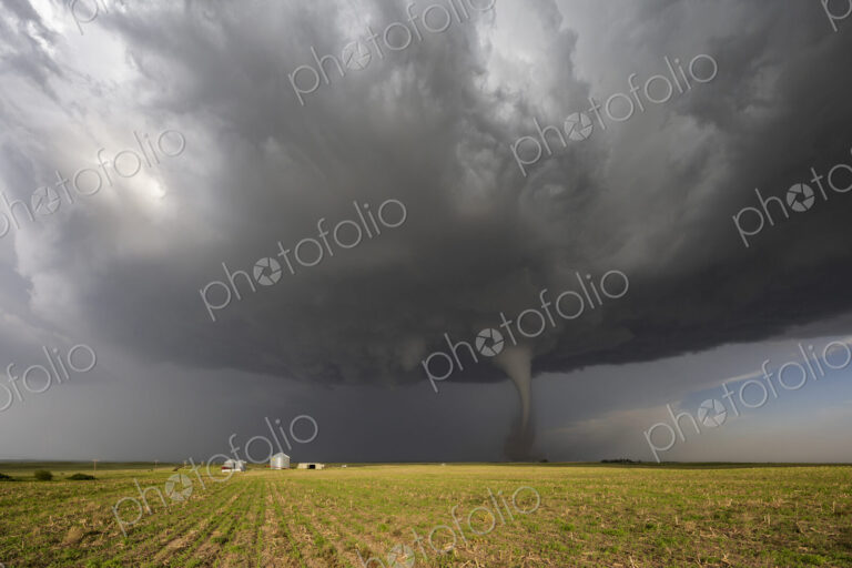 Fully Condensed Tornado, a rotating column of air reaching to the ground, a defined shape.