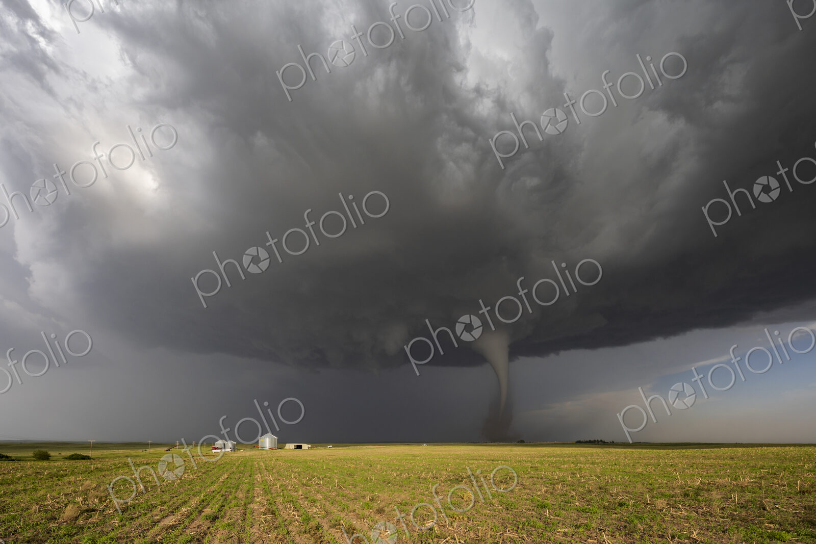 Fully Condensed Tornado, a rotating column of air reaching to the ground, a defined shape.