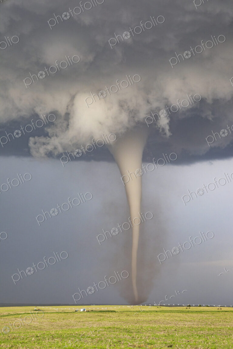 Fully Condensed Tornado, a rotating column of air reaching to the ground, a defined shape.