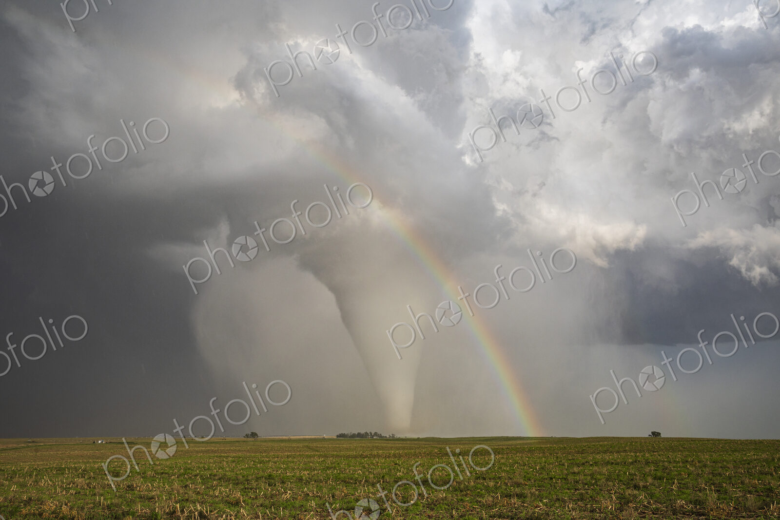 Fully Condensed Tornado with a Rainbow, a spiralling column of air reaching the ground.