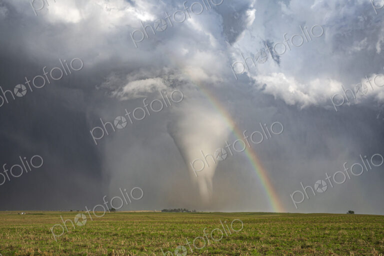 Fully Condensed Tornado with a Rainbow, a spiralling column of air reaching the ground.