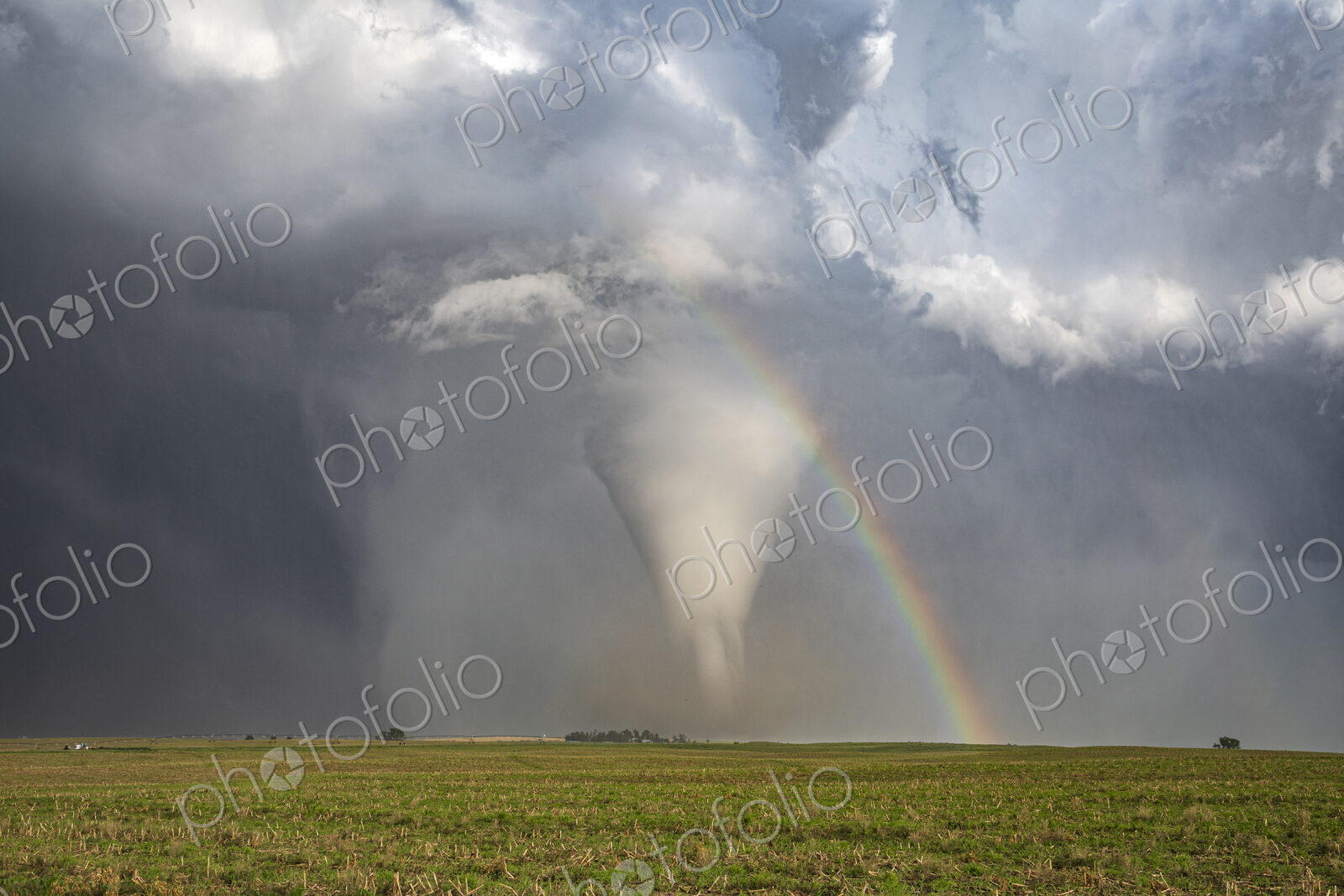 Fully Condensed Tornado with a Rainbow, a spiralling column of air reaching the ground.